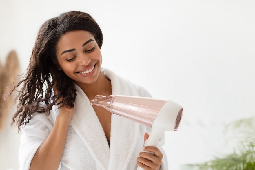 Woman blow drying her hair