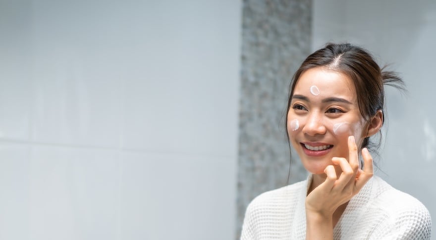 Women applying moisturizer